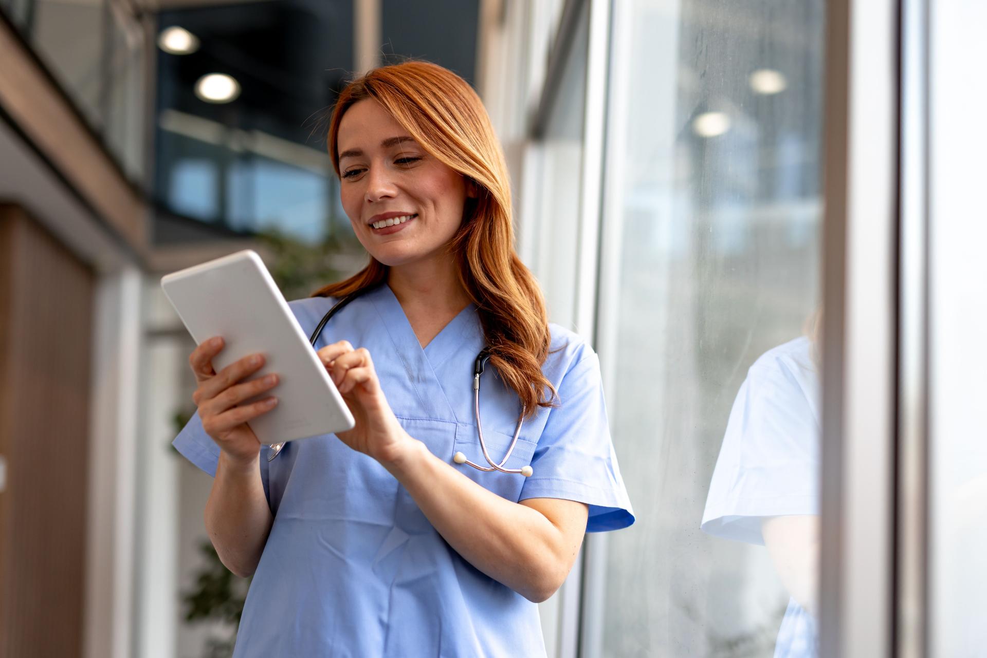 Smiling Nurse Using a Tablet in a Modern Healthcare Facility